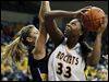 University of Toledo center Yolanda Richardson (33) goes to the net against Marquette's Cristina Bigica (35) Saturday.