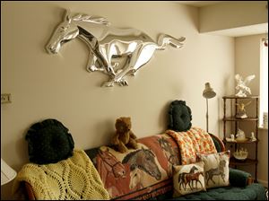 Collect-Call-Horses-Lynn-Burns-living-room.jpg From the blankets to the pillows to the chrome art of the Ford Mustang trademark, Lynn Burns' living room in West Toledo is full of horses.