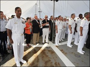 Navy-Week-De-Wert-Commander-Thomas-National-Anthem.jpg Commander Joseph Thomas, commanding officer of the U.S. Navy frigate USS De Wert, front left, stands with others during the singing of the National Anthem.