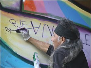 Broadway-murals-2010-Torero.jpg Well-known artist Mario Torero works on one of the first murals in 2010.