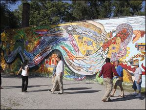 Broadway-murals-OLA-serpent.jpg Members of the Organization of Latino Artists gather their main mural of a feather serpent that symbolizes one of the gods in the Aztec culture.