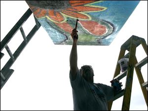 Broadway-murals-Gordon-Ricketts-orange-flower.jpg Gordon Ricketts, director of the Arts Village at Bowling Green State University, paints a part of a mural in the Old South End.