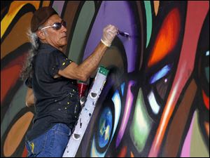 Broadway-murals-Torero-viaduct.jpg Mario Torero, of San Diego, works on a mural on the viaduct below I-75 on Broadway in 2011.