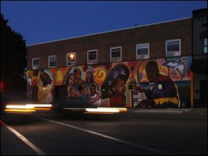 Broadway-murals-1200-block.jpg A mural by BGSU students in the 1200 black of Broadway represents local people.