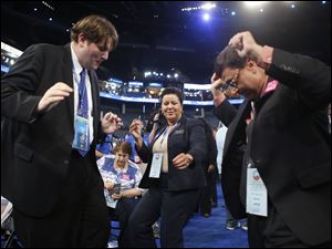 Democratic-Convention-Sam-Spencer-Gwen-Wilkins-Roy-Sanyal.jpg North Carolina delegates Sam Spencer, left, Gwen Wilkins and Roy Sanyal dance as they arrive on the floor.