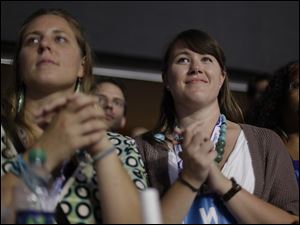 Democratic-Convention-women-clap.jpg Delegates listens as first lady Michelle Obama addresses the Democratic National Convention.