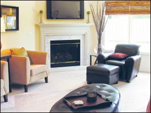 Brookridge-living.jpg A gas fireplace with marble surround anchors the room while 10-foot ceilings tower above.