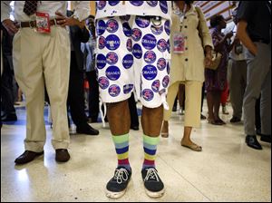 Democratic-Convention-Chris-Porter.jpg Covered with stickers, Washington state delegate Chris Porter waits in line at a concession stand at the Democratic National Convention.