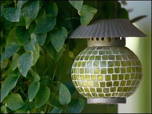 FEA-wiarjanice01p-candle-holder.jpg A candle holder blends with the surrounding greenery.