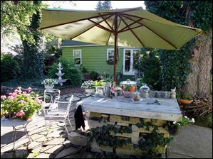 FEA-wiarjanice01p-cooking-area.jpg A stone cooking station provides function to the yard.