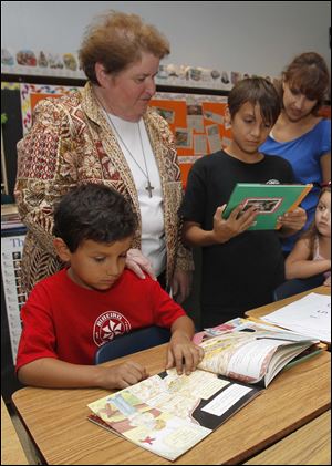 CTY-reading11p-1.jpg Sister Frances Marie watches Augustine Vallejo, 7, and his brother Armando Vellejo, right, as they choose free books.