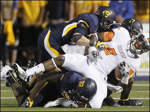Bowling-Green-receiver-Shaun-Joplin.jpg Bowling Green receiver Shaun Joplin is brought down by Toledo defenders Junior Sylvestre, 33, Mark Singer, 43, and Cheatham Norrils, 11, during the second quarter of their football game at the Glass Bowl in Toledo.