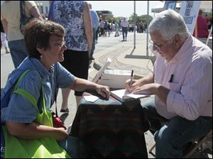 Phyllis-Hinkle-of-Toledo.jpg Phyllis Hinkle, of Toledo, left, has author Frank E. Kuron, right, autograph a copy of his book