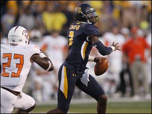 University-of-Toledo-quarterback-Terrance-Owens.jpg University of Toledo quarterback Terrance Owens is pursued by BowlingGreen defensive back Aaron Foster during the second quarter of their football game at the Glass Bowl in Toledo.