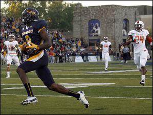 University-of-Toledo-wide-receiver.jpg University of Toledo wide receiver Alonzo Russell (9) scores a touchdown against Bowling Green during the first quarter.