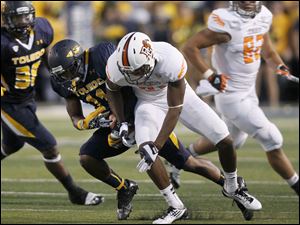Toledo-defensive-back-Cheatham-Norrils.jpg Toledo defensive back Cheatham Norrils, 11, left, intercepts a pass intended for Bowling Green receiver Chris Gallon, 81, during the second quarter of their football game at the Glass Bowl in Toledo.