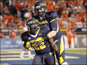 Toledo-running-back-David-Fluellen.jpg Toledo running back David Fluellen, 22, celebrates with teammate Zac Rosenbauerafter scoring a touchdown during the second quarter of the Rockets' football game against Bowling Green at the Glass Bowl in Toledo.