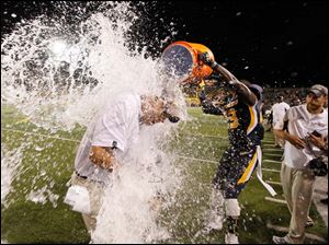T-J-Fatinikun-2.jpg Toledo football coach Matt Campbell is doused with water by T.J. Fatinikun, 23, after the Rockets won.