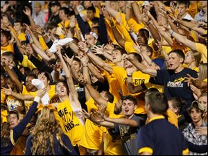 free-T-shirt.jpg Toledo students try to grab a free T-shirt being thrown by cheerleaders.