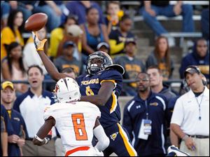 Alonzo-Russell.jpg Toledo wide receiver Alonzo Russell, back, leaps for a pass against Bowling Green cornerback Cameron Truss.