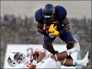 Running-back-David-Fluellen.jpg Toledo running back David Fluellen leaps over Bowling Green defender Ryland Ward.