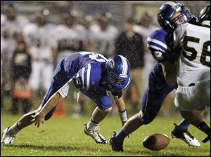 SPT-NLLfootball22p-1.jpg Anthony Wayne quarterback Jake Reid (12) fumbles the ball against Perrysburg.