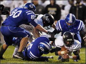 SPT-NLLfootball22p-12.jpg Perrysburg running back Trenton Demmerling (27) dives for yardage.