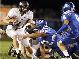 SPT-NLLfootball22p-6.jpg Perrysburg quarterback Steve Slocum (1) runs the ball against Anthony Wayne's Mike Deck (72) and Hunter Johnson (8).