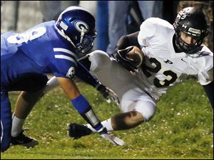 SPT-NLLfootball22p-8.jpg Perrysburg wide receiver Austin Bishop (23) makes a catch against Anthony Wayne's Hunter Johnson (8).