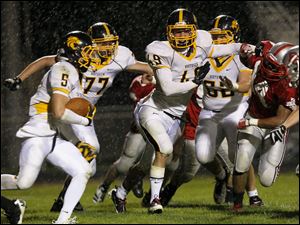 WEBsylv-northviewfball22p-3.jpg Connor Zipfel, of the Northview Wildcats, tries to block off Israel Vento, of the Bowling Green Bobcats, as Mark Bernsdorff tries to run the ball.