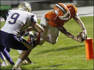 WEBsylv-southviewfball22p-1.jpg Southview's senior quarterback Austin Valdez eludes Maumee's senior defensive back Steve Duby for a touchdown during Friday's game at Northview. A flag on the play invalidated the touchdown.