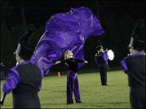WEBsylv-southviewfball22p-10.jpg Maumee marching band member Mandy Rizzo, 17, center, performs with the band during halftime.