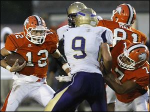 WEBsylv-southviewfball22p-5.jpg Southview's senior quarterback Damian Greisiger switches directions as he avoids defensemen.