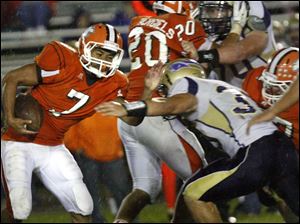 WEBsylv-southviewfball22p-8.jpg Southview's senior running back Ahmad Parker dodges Maumee defenders.
