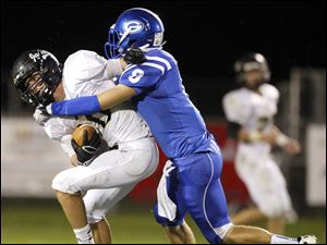 SPT-NLLfootball22p-9.jpg Perrysburg wide receiver Austin Lee (10) makes a catch against Anthony Wayne's Hunter Johnson (8).