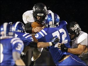 SPT-NLLfootball22p.jpg Perrysburg running back Trenton Demmerling (27) leaps for yardage.