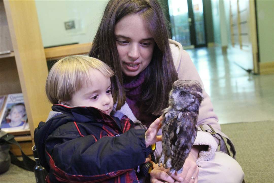 Heather-Gillen-of-Maumee-holds-a-stuffed-owl-for-her-son