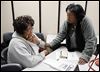  Wendy Easler, right, helps Deborah Foreman of Toledo with her taxes Friday at the Financial Opportunity Center in North Toledo.