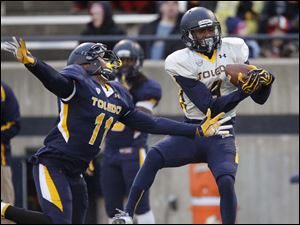 UT-spring-game-Alonzo-Russell.jpg Toledo Rockets gold team receiver Alonzo Russell catches a pass in front of blue team cornerback Cheatham Norrils.