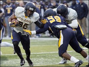 UT-spring-game-Ricky-Pringle.jpg Toledo Rockets gold team running back Ricky Pringle runs past blue team linebacker Alvin Fletcher to score a touchdown.