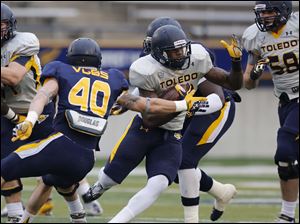 UT-spring-game-elude.jpg Toledo Rockets gold team running back David Fluellan eludes the grasp of blue team linebacker Trent Voss.