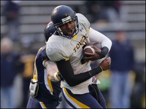 UT-spring-game-wrapped-up.jpg Toledo Rockets gold team quarterback Terrance Owens is grabbed by blue team linebacker Trent Voss.