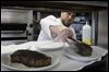 FUD-steak06p-filet-and-strip-steaks.jpg Chef Tim Childers places a 10-ounce filet mignon onto a plate a plate next to a 14-ounce New York strip at Rockwell's.