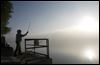  Terry Van Bibber, Toledo, casts his line out into the Maumee River as fog envelops the area.
