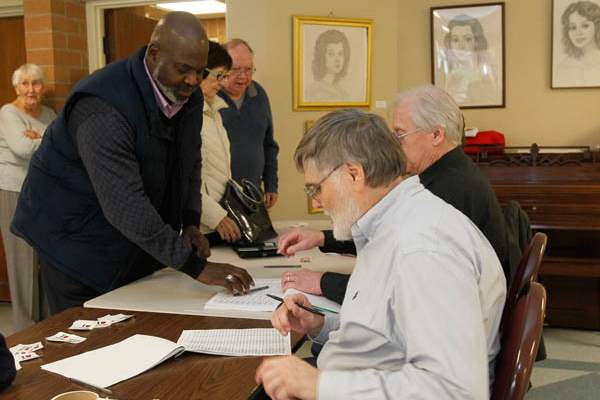 Mayor-Mike-Bell-left-signs-in-before-voting