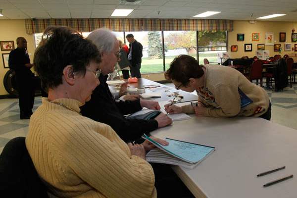Poll-workers-Jill-left-and-Art-Keller-as-voter-M