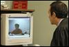 n3arraign.jpg Andrew Gans, on the monitor, listens to Judge John P. Kolesar during his video arraignment. Mr. Gans, 24, is being held on $1 million bond in the aggravated vehicular homicides of Wilbur and Margaret McCoy of Toledo on Thanksgiving night.