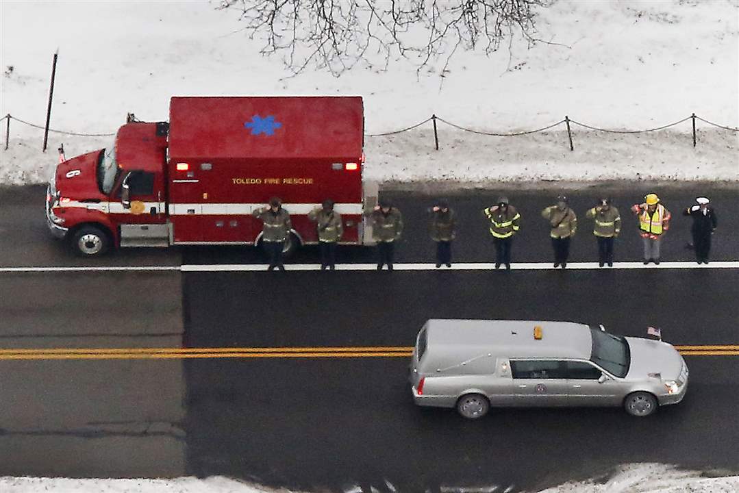 Toledo-firefighters-salute-as-the-hearse-carrying-Tol