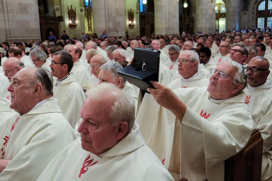 CTY-BIshop23A-priest-takes-a-photo-with-his-iPad
